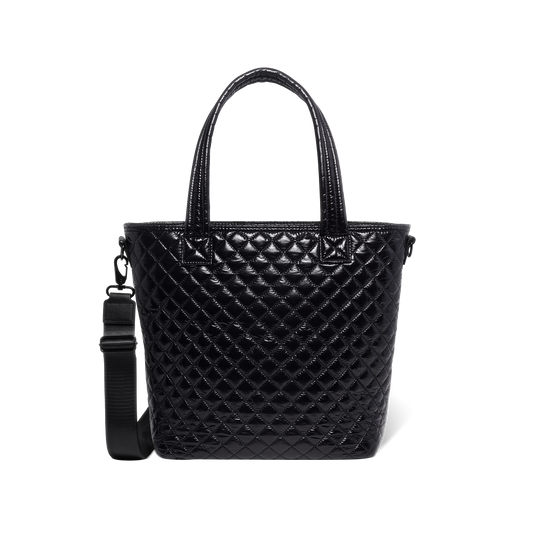 Black quilted handbag with light reflections on white background