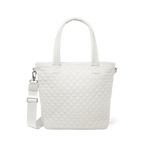 Cream-colored quilted tote bag with dual white handles against a white background