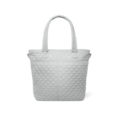 Back view of pale gray quilted tote bag with soft texture against white background, showing quilted pattern and design details from rear perspective.