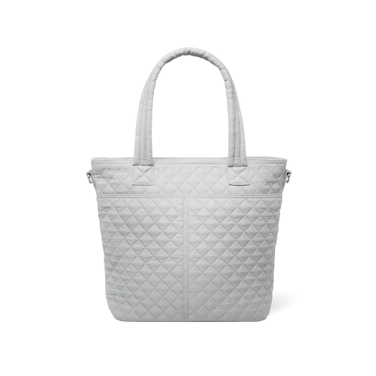 Back view of pale gray quilted tote bag with soft texture against white background, showing quilted pattern and design details from rear perspective.