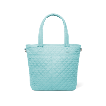 Pale turquoise quilted tote bag with diamond pattern design, shown from back view against white background