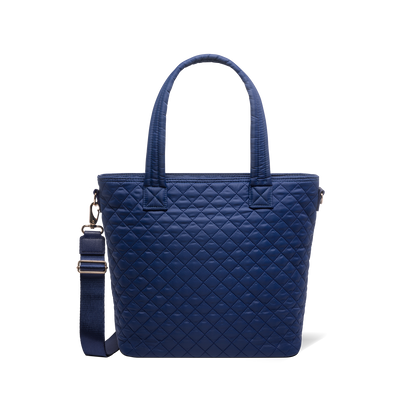 Navy blue tote bag with carabiner clip and metal hardware accents on shoulder strap