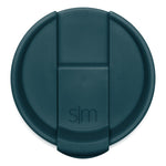 Teal-colored circular lid with raised rim, photographed from above against white background.