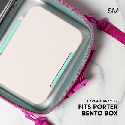 Magenta pink hardshell zippered pouch with sage green body, showing fitted bento-style compartments inside.