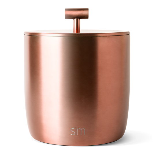 Brushed rose gold and copper metallic surface with light reflections, transitioning from peachy tones on the left to deeper bronze hues on the right.