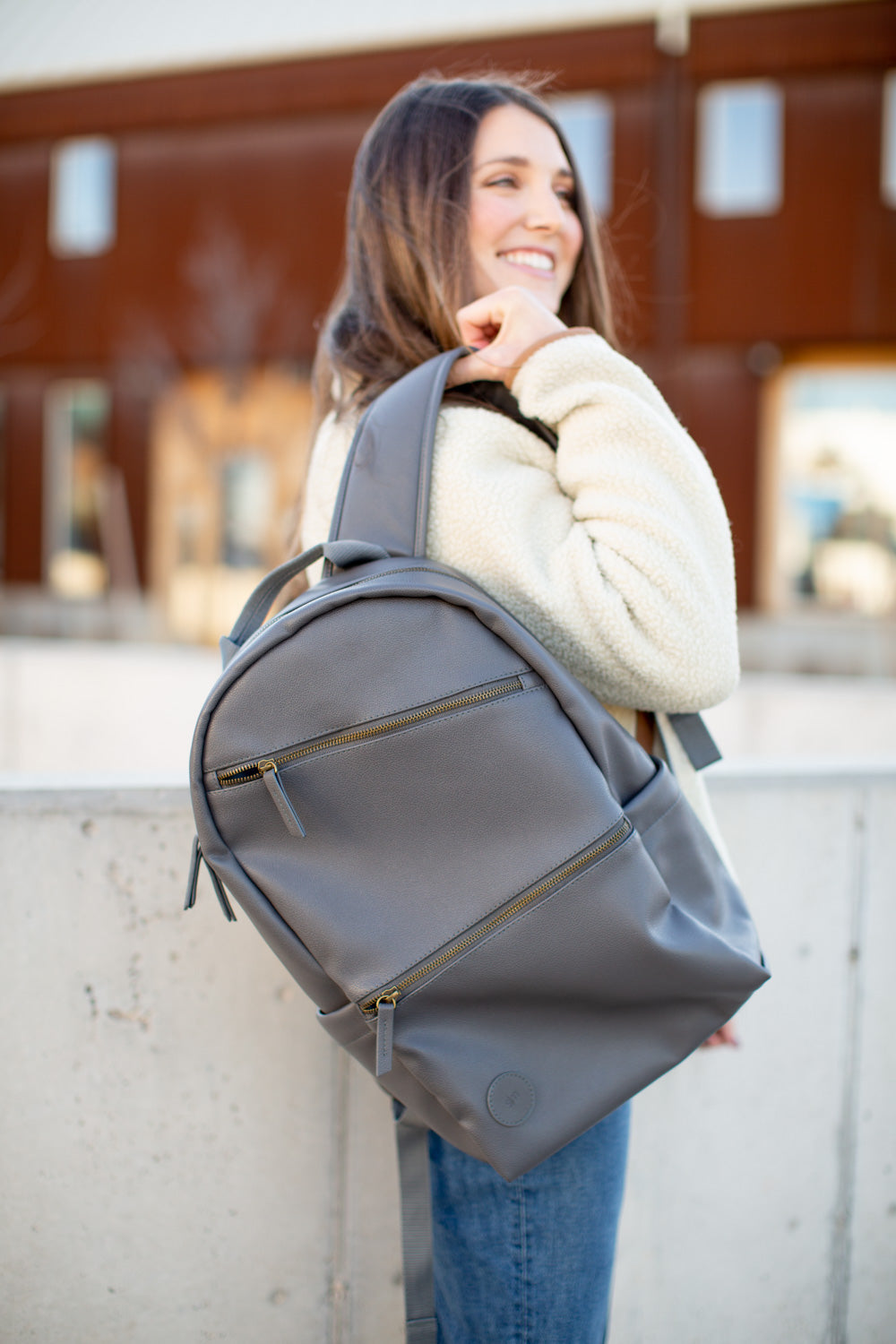 Gray-blue Simple Modern backpack with cream accents on neutral gray background