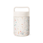 Cream-colored cylindrical container with terrazzo-patterned lower section featuring multicolored speckles on neutral background