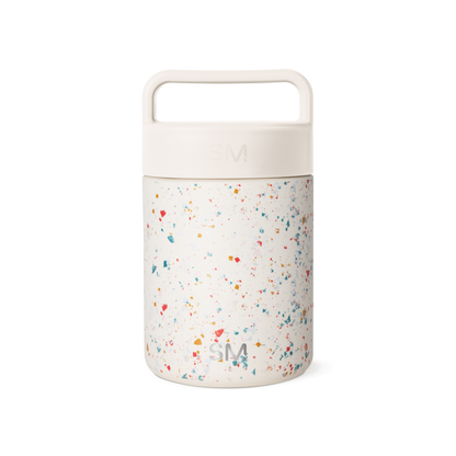 Cream-colored cylindrical container with terrazzo-patterned lower section featuring multicolored speckles on neutral background