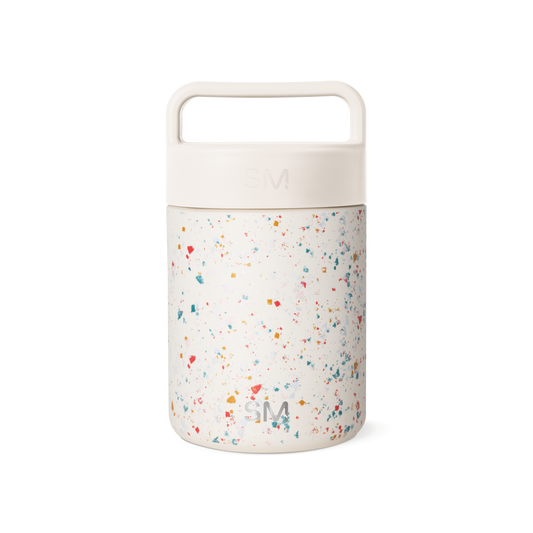 Cream-colored cylindrical container with terrazzo-patterned lower section featuring multicolored speckles on neutral background