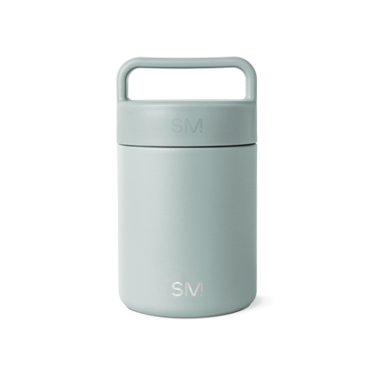 Sage green glass jar with white background, featuring a minimalist design and neutral aesthetic