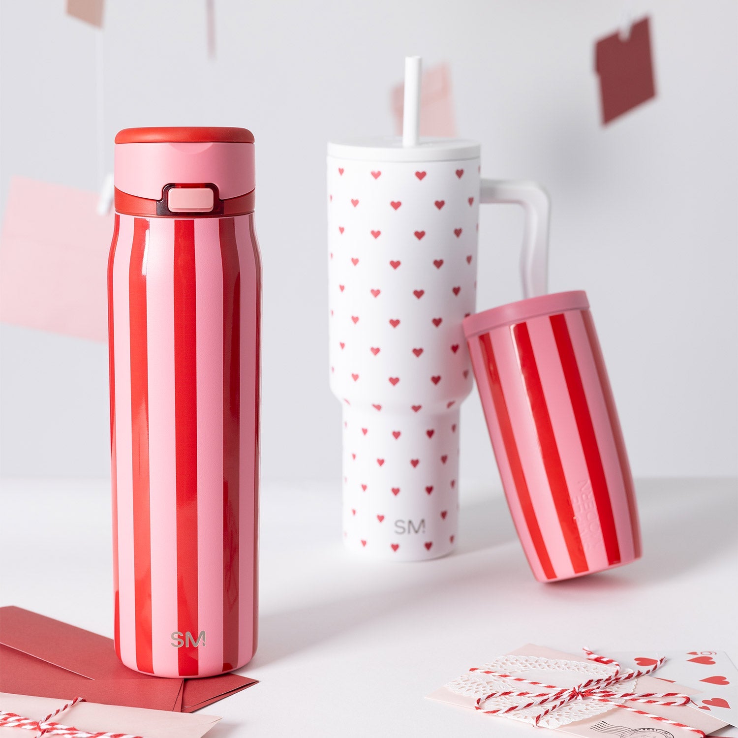 Red and light pink vertical striped fabric or garment against a white background, featuring a romantic color palette with soft pink and bright red tones.