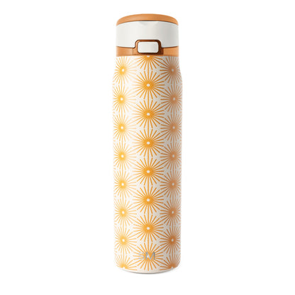 Cream cylindrical bottle with repeating geometric pattern in warm golden orange on neutral background