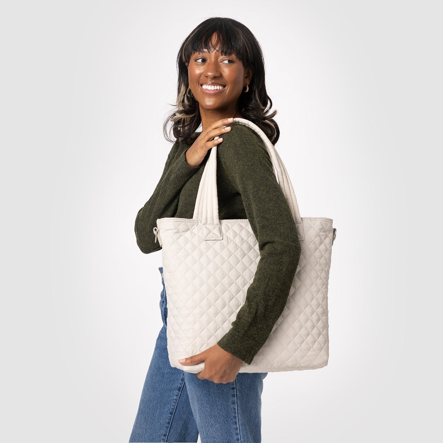 Quilted Harper bag in cream with olive-green and blue denim accents on light gray background