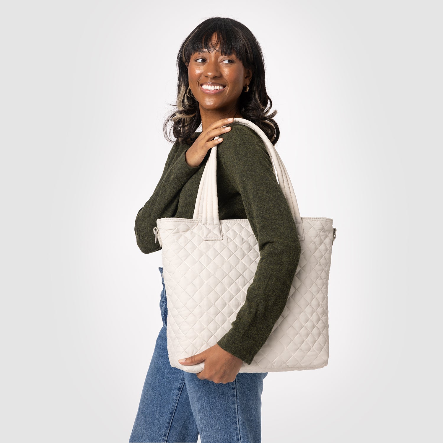 Quilted Harper bag in cream with olive-green and blue denim accents on light gray background