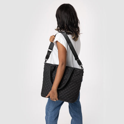 Quilted Harper Crossbody Bag in light gray with quilted texture pattern, displayed against a soft gray background.