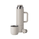 Greige-toned coffee maker with neutral beige-gray exterior walls and soft interior components visible on the lid and brewing chamber