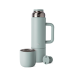 Sage green insulated thermos with matching cap and cup, displayed with handle and accessories against white background