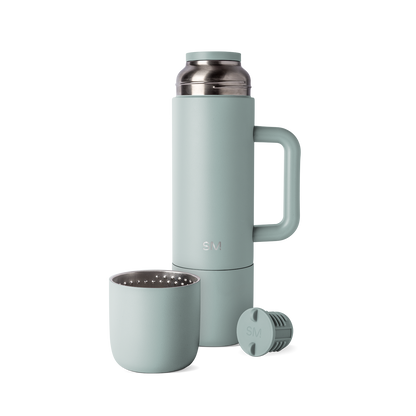Sage green insulated thermos with matching cap and cup, displayed with handle and accessories against white background