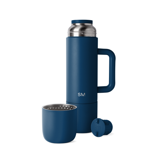 Navy blue romertopf clay baker with stainless steel silver handles and lid knob, displayed against a white background.