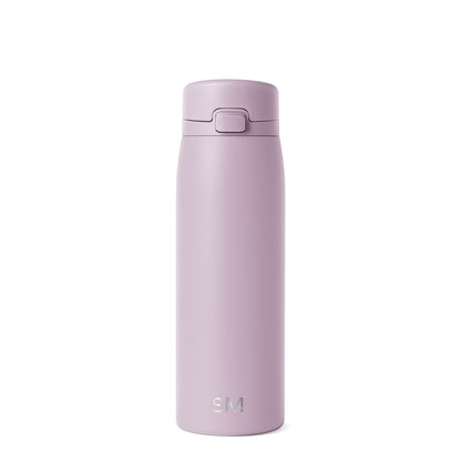 Soft mauve glass bottle with dusty lilac coloring displayed against a neutral off-white background