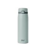 Soft sage green glass bottle with darker charcoal accents, featuring a minimalist design against a neutral background.