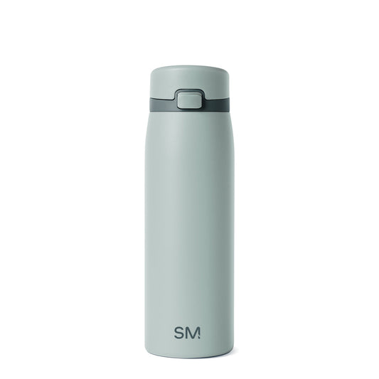 Soft sage green glass bottle with darker charcoal accents, featuring a minimalist design against a neutral background.