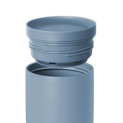 Blue-gray water bottle with detachable lid on white background. Simple modern design in muted slate blue color.