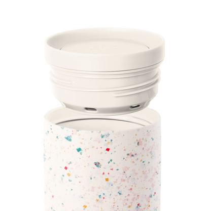 Cream-colored two-piece cookware set with removable lid on white background, featuring a light cream base vessel and off-white top component.
