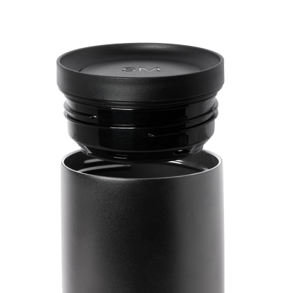 Dark gray cylindrical container with matte finish and removable black lid, shown against white background.