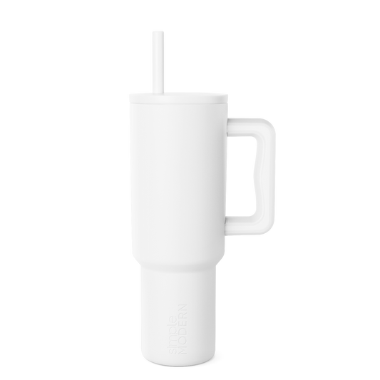 White insulated tumbler with matching white straw on light gray background