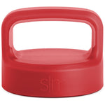 Coral-red product with handle, viewed from above showing consistent saturated color with subtle tonal variations across the exterior surface.