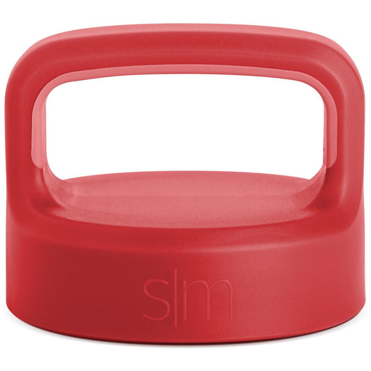 Coral-red product with handle, viewed from above showing consistent saturated color with subtle tonal variations across the exterior surface.