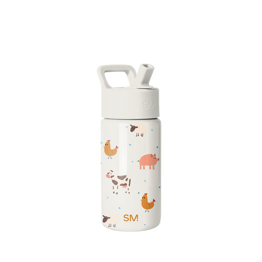 Simple Modern water bottle with cream-white base, farm animal illustrations in warm orange and yellow tones, white screw-on cap with flip-top straw spout and handle loop, SM logo displayed on lower portion.