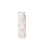 White and pink Simple Modern water bottle with straw cap, carry handle, and repeating bow pattern design. SM logo on cap and body. Studio product photo on neutral background.