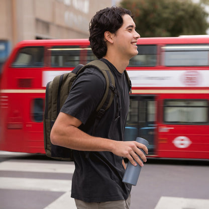 Bright red double-decker bus in urban setting with neutral background