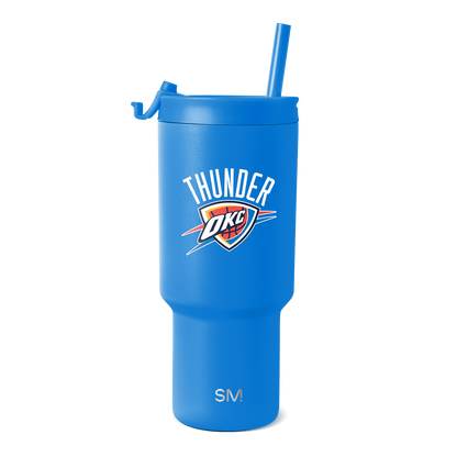Royal blue insulated tumbler with white, red, orange, and navy blue design accents on cylindrical body