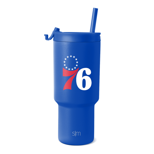 Royal blue tumbler with white text and red swoosh design element