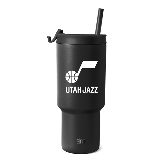 Matte black insulated tumbler with matching black straw and lid cap, featuring a cylindrical design with charcoal undertone for a monochromatic look.