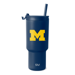 Deep navy blue tumbler with bright golden yellow "M" logo and white text at the bottom