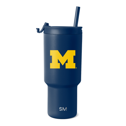 Deep navy blue tumbler with bright golden yellow "M" logo and white text at the bottom