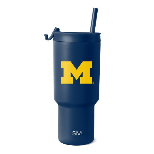 Deep navy blue tumbler with bright golden yellow "M" logo and white text at the bottom