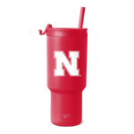 Crimson red tumbler with matching red straw on white background