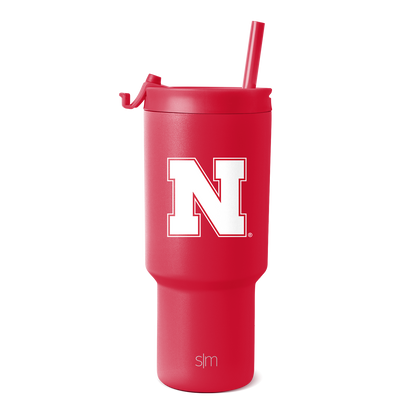 Crimson red tumbler with matching red straw on white background