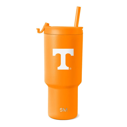 Bright orange tumbler with matching orange straw on white background