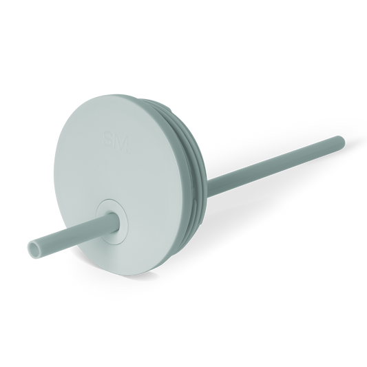 Soft sage green circular lid with cylindrical straw housing and neutral teal accents, suitable for beverages and daily use.