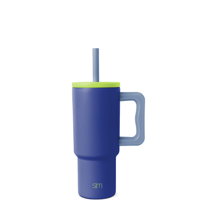 Navy blue tumbler with vibrant lime green lid, rim band, and handle for secure grip and easy carrying.