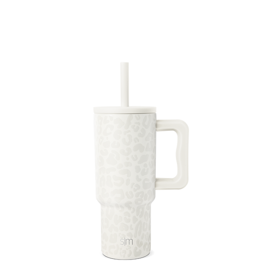 White tumbler with white straw on light gray background