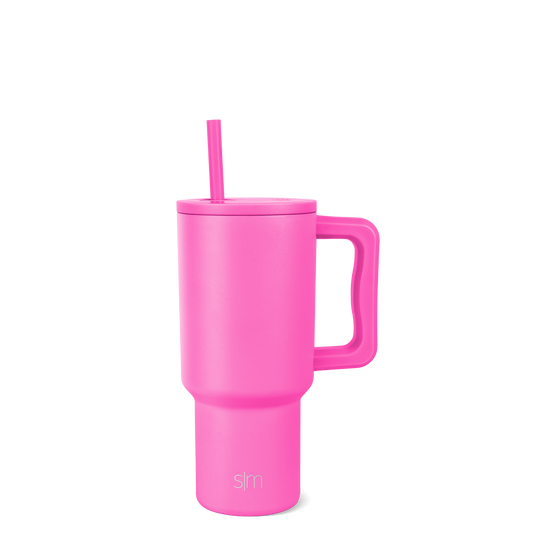 Hot pink tumbler with lid and straw on white background