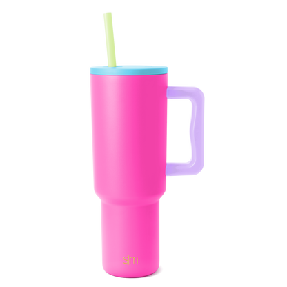 Trek Tumbler insulated beverage cup with hot pink body, sky blue lid, lavender purple handle, and pale yellow-green straw on white background