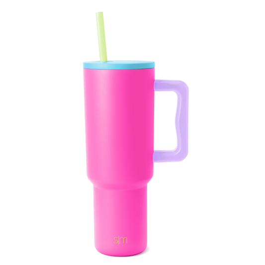 Trek Tumbler insulated beverage cup with hot pink body, sky blue lid, lavender purple handle, and pale yellow-green straw on white background